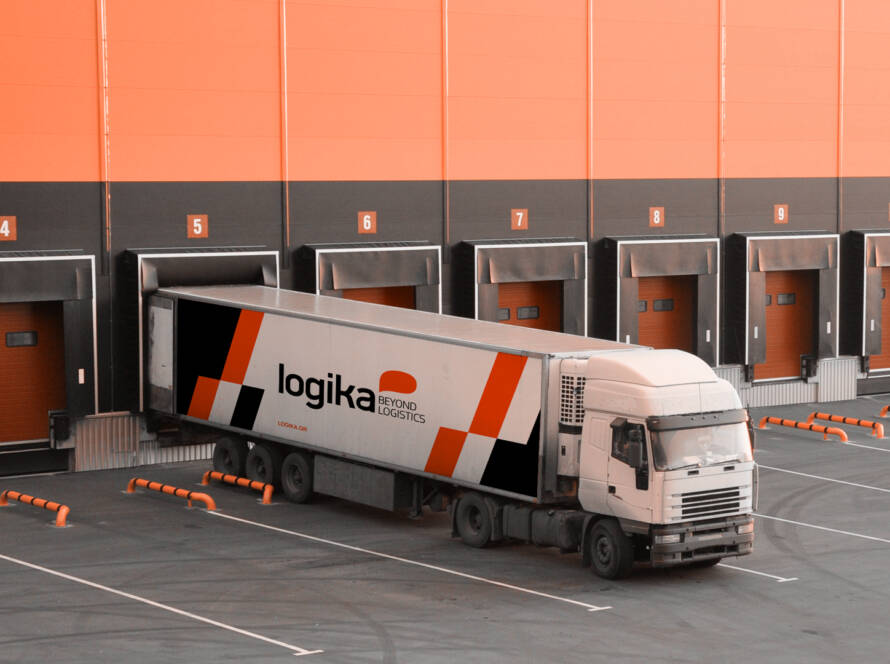 Unloading trucks at a modern warehouse complex. Logistics.